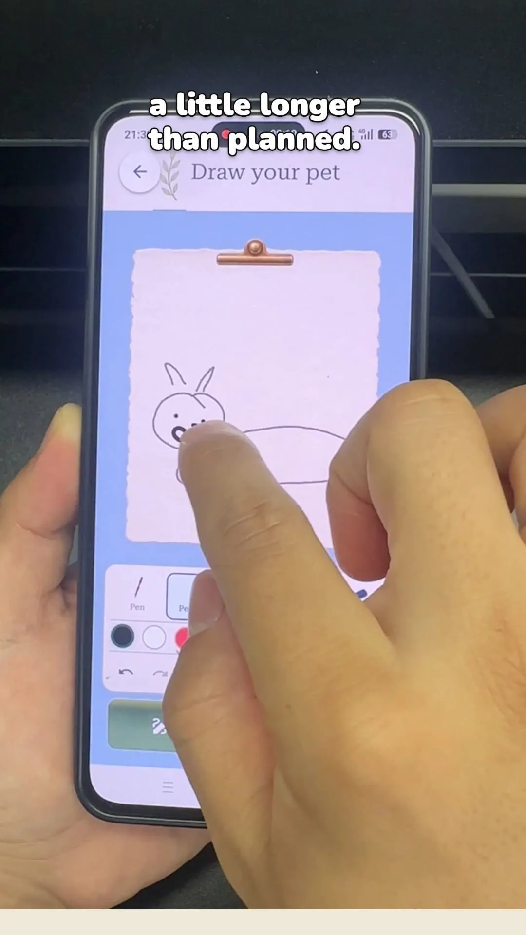 A person extending the doodle into a long body after drawing its face and ears.
